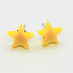 Simple, cute, and yellow. No real description needed...unless you like, can't see. In which case, they're little stars made from acrylic, and they'd look great on you.  Product Description:  Dimensions: 1 cm x 1 cm x 3 mm Lightweight but sturdy High quality glossy Bright Yellow Acrylic  Metal studs are hypoallergenic stainless steel Ships with a small jewelry box with both rubber and stainless steel earring backs. Cheap Yellow Minimalist Earrings, Yellow Star Earrings, Star Earring, Star Clothing, Yellow Accessories, Yellow Star, Small Jewelry Box, Star Earrings Stud, Earring Studs