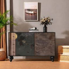 a vase with flowers on top of a wooden cabinet next to a plant in a wicker basket