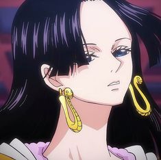 a woman with long black hair wearing earrings