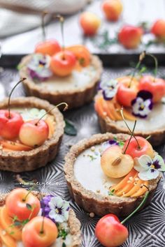 small tarts with fruit and flowers on them