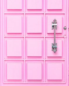 a pink door with several square tiles on it