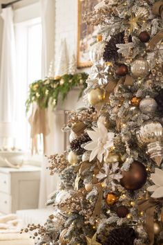 a decorated christmas tree with gold and silver ornaments