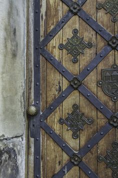 an old wooden door with metal designs on it