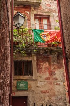 an orange and green flag is hanging on the balcony