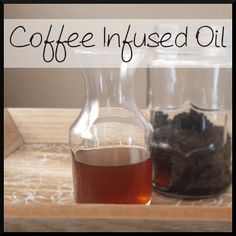 coffee infused oil is sitting on a tray next to an empty glass bottle and some black tea