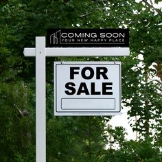 a white for sale sign sitting in front of some green trees with the words coming soon on it