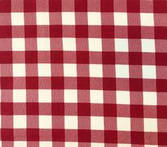 a red and white checkered tablecloth is shown in close up, it looks like the fabric has been woven on