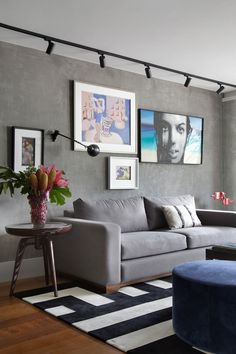 a living room filled with furniture and pictures on the wall