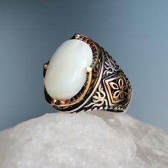 "White Mother of Pearl Stone Silver Ring, Handmade Sterling Silver Ring, 925 Silver Handmade Mens Ring, Unique Gemstone Vintage Style Gift for Him The middle stone is Mother of Pearl Aquamarine. Red micro stones between the decorative motifs on the arms of the ring creates a magnificent aesthetic to the ring. About Mother of Pearl Gemstone: Mother-of-pearl is a limestone substance composed of salt, lime and phosphorus in the flowing waters of warm seas. There are varieties such as white, arusek, White Oval Gemstone Signet Ring, White Gemstone Signet Ring Gift, Heirloom White Signet Ring With Polished Finish, White Sterling Silver Signet Ring With Gemstone, White Gemstone Signet Ring In Sterling Silver, White Oval Heirloom Signet Ring, Heirloom White Oval Signet Ring, Heirloom White Gemstone Rings, Anniversary White Stone Rings