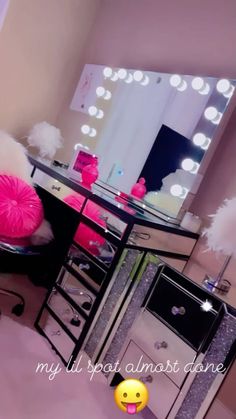 a room with a vanity, mirror and pom poms