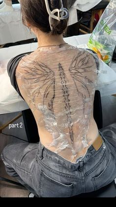 the back of a woman's body covered in plastic