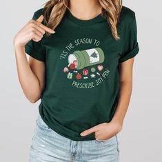 This Christmas Pharmacy Shirt is a perfect way to celebrate your favorite Pharmacist during the Holiday Season! Crafted by Serenity is the ONLY authorized seller of this Christmas Pharmacy Shirt. ✦KEY FEATURES:: .: 100% Airlume combed and ringspun cotton (fiber content may vary for different colors) .: Light fabric (4.2 oz/yd² (142 g/m .: Retail fit .: Tear away label .: Runs true to size ✦CARE INSTRUCTIONS:: Machine wash: warm (max 40C or 105F); Non-chlorine: bleach as needed; Tumble dry: low heat; Iron, steam or dry: medium heat; Do not dryclean. .:DISCLAIMER: Product color may slightly vary due to photographic lighting sources or your monitor settings CUSTOMER SERVICE: Any questions, please message us before placing your order and we will be more than glad to assist you! Thank you for s Pharmacy Christmas Shirts, Pharmacy Tech Shirt Ideas, Pharmacy Tech Svg, Pharmacy T Shirt Ideas, Pharmacy Tshirt Design, Christmas Pharmacy Shirt, Pharmacy Tech Shirts, Pharmacy Technician, Pharmacy Tech