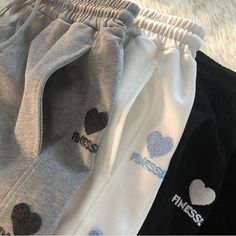 Stay Comfy and Stylish with Heart Embroidery Sweatpants! ❤️👖 🌟 Casual and Cute: Our sweatpants are designed for those who appreciate the charm of casual fashion and want to make a style statement that's both comfortable and complete. Ideal for individuals who love to blend fashion and comfort effortlessly. ✨ Superior Quality: Crafted with precision to ensure top-notch quality and comfort. These sweatpants are designed to keep you looking stylish and comfortable, whether you're lounging at home Trendy Cotton Sweatpants, Cotton Letter Print Bottoms For Winter, Winter Cotton Bottoms With Letter Print, Trendy Winter Cotton Joggers, Winter Cotton Pants With Letter Print, Trendy Letter Print Pants For Winter, Trendy Pants With Letter Print For Winter, Trendy Cotton Sweatpants For Winter, Trendy Winter Pants With Letter Print