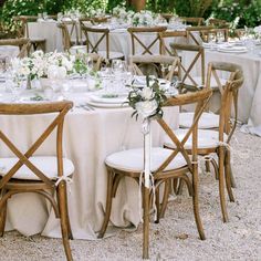 the tables are set with white linens and centerpieces for an elegant wedding reception