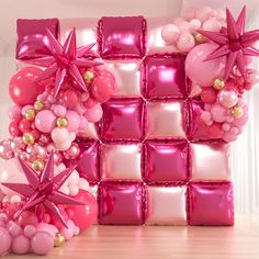 pink and white balloons are arranged in the shape of a cube with stars on it