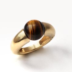 "Tiger Eye Geometric Cocktail Ring. FREE EXPRESS SHIPPING! Your new jewelry direct to your door! The Donut Tiger eye stone ring's benefits are beyond words: it is an incredible stone for achieving clarity. Traditionally carried as a talisman, this tiger ring is hand-forged for those who are glamorous and not afraid to show it. This sweet and colorful piece can also make the perfect birthday gift. If you love this piece with its inspiring tiger eye design, then you'll love our Blue round stone ri Modern Gold Crystal Ring With Gemstone, Modern Gold Stackable Gemstone Rings, Modern Gold Stackable Rings With Gemstones, Modern Gold Signet Ring With Cabochon, Modern Gold Rings With Round Stone, Modern Stackable Gold Rings With Gemstones, Modern Yellow Gold Rings With Gemstone, Modern Gold Ring With Round Stone, Modern Yellow Gold Cabochon Rings