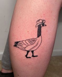 a bird with a hat on it's head is shown in this tattoo design