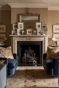 a living room filled with furniture and a fire place in front of a mirror on the wall