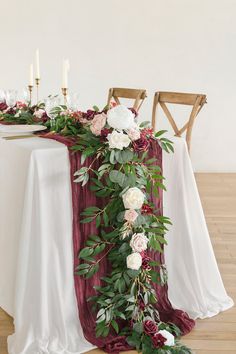 the table is decorated with flowers and greenery