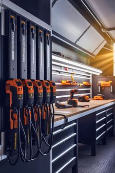 a bunch of tools are lined up on the wall in a room with many drawers