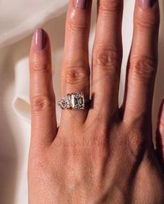 a woman's hand with a ring on it