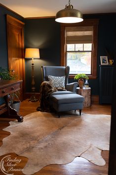 a living room filled with furniture and a cowhide rug