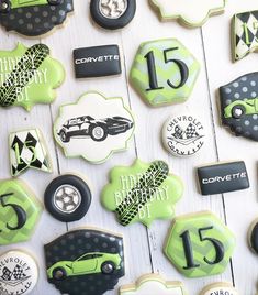 decorated cookies with cars and numbers are displayed on a white wooden surface, along with the words happy birthday