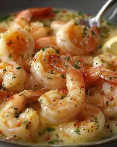 a bowl filled with shrimp and garnished with lemon wedges