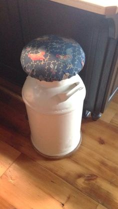 a white container sitting on top of a hard wood floor next to a black radiator