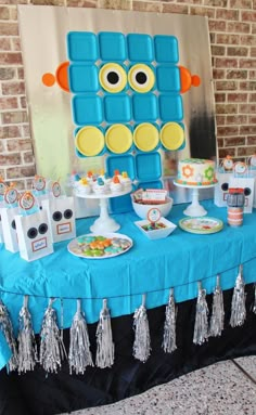 a blue table topped with cakes and desserts