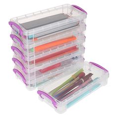 a plastic storage box filled with lots of different colored pens and pencils on top of each other