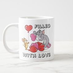 a white coffee mug with an elephant and heart balloons on the front, filled with love