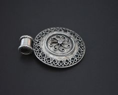 "A round and medium sized Indian sterling silver amulet. All the silver ornamentations are fully intact and it looks really pretty. The back is stamped 925 and the long bale is large enough for a thicker chain or cord. Measurements are: Diameter Amulet 3.5cm (1.4\") Weight: 11gr. This pendant ships registered priority and with tracking ❀ Please read my shop and return policies before purchasing ❀ https://www.etsy.com/shop/CosmicNorbu/policy?ref=shopinfo_policies_leftnav" Traditional Round Disc Jewelry As Gift, Traditional Nickel-free Round Pendant Jewelry, Indian Pendant, Nepali Jewelry, Lapis Pendant, Tibetan Jewelry, Hand Of Fatima, Coral Turquoise, Ethnic Jewelry