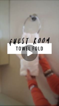 a person holding a toilet paper roll in front of a bathroom mirror with the words finest room towel fold on it