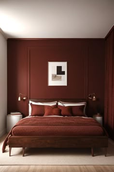 a bed with red sheets and pillows in a bedroom next to a painting on the wall