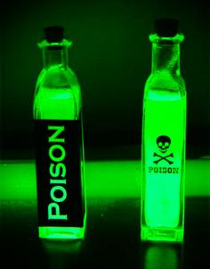 two bottles with glow in the dark and one has a skull sticker on it