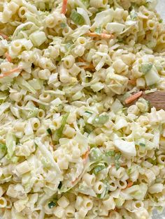 a bowl filled with macaroni salad on top of a table