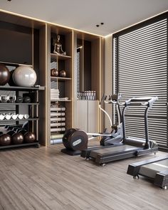 there is a gym with treadmills and exercise equipment in the room that also has shelves