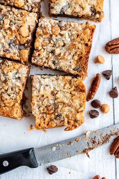 a bunch of food sitting on top of a table next to a knife and some pecans