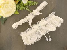 Make a stunning statement with our Elegant White Guipure Crochet Lace Garter. Handcrafted with care, this garter features beautiful white guipure crochet lace adorned with a satin black ribbon, black feathers, and iridescent stones. The contrasting colors and textures create a captivating and glamorous design. Whether you're looking to enhance your bridal ensemble or add a touch of elegance to special occasions, this garter is the perfect accessory. The white guipure crochet lace exudes a classi Crochet Garter, Bridal Garter Lace, Nottingham Lace, Lace Garter, Bridal Garter, Black Feathers, Black Ribbon, Bridal Lace, Lingerie Collection