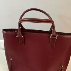 Nwot Lamarthe Genuine Leather Shoulder Handbag Burgundy W/ Silver Hardware Measures 14-1/2” W X 11” H 2 Large Top Zippered Pockets Large Open Middle For Storage- Snap Closure Made In Italy Comes With Dust Bag Business Tote Bag With Silver-tone Hardware, Classic Satchel With Silver-tone Hardware In Tote Shape, Classic Satchel Tote With Silver-tone Hardware, Business Bags With Silver-tone Hardware, Burgundy Leather Shoulder Bag With Palladium Hardware, Burgundy Tote Satchel For Office, Burgundy Office Tote Satchel, Office Tote Bag With Silver-tone Hardware, Red Business Bag With Silver-tone Hardware