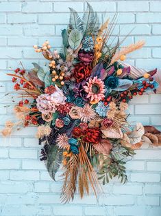 a bunch of flowers that are sitting on a brick wall