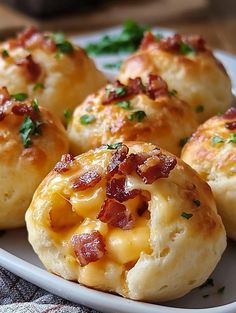 some bacon and cheese rolls on a white plate with parsley sprinkled around them