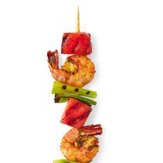 shrimp skewers with celery and watermelon on a white background