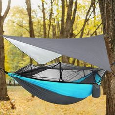 a hammock hanging from a tree in the woods