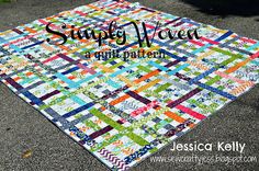 a patchwork quilt is laying on the ground