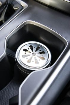 the interior of a car with an automatic gear box and cup holder in it's center console