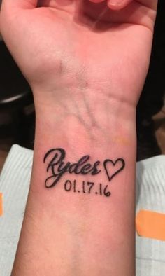 a woman's wrist tattoo with the words rules and hearts