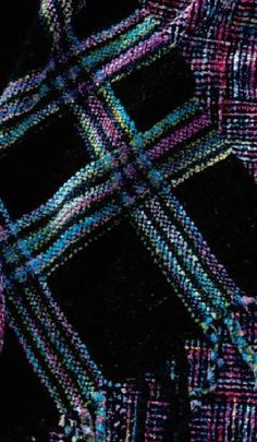 an abstract black background with multicolored squares and lines on it's surface