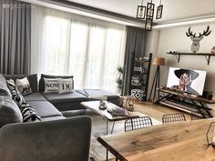 a living room filled with furniture and a flat screen tv sitting on top of a wooden table